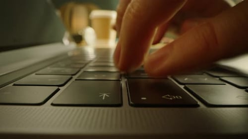 Close-up Moving Macro Shot: Person Typing on Laptop Keyboard finishing with Pressing Enter Button.