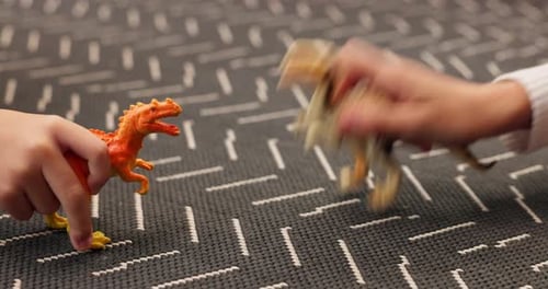 Children, hands and play with dinosaur in home for fun activity, imagination