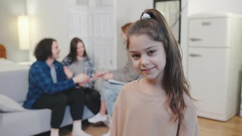 Smiling Girl with Family in Living Room