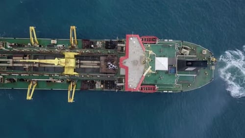 Trailing Suction Hopper-Dredger ship roaring across the sea