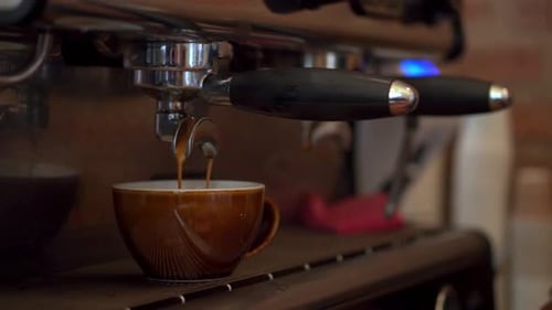 Close up of Professional machine pouring Coffee in a cup, Coffee shop concept