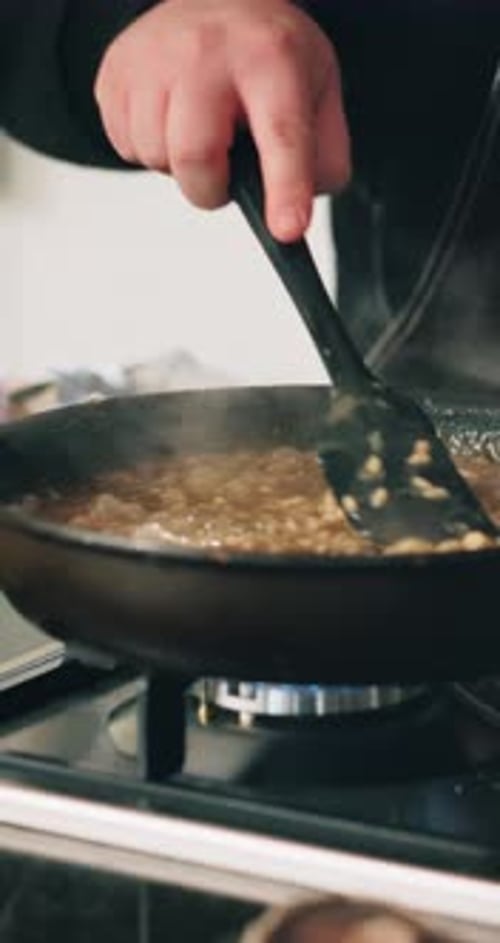 Cooking Food in Skillet on Stove Top