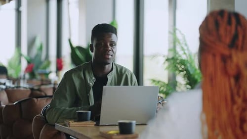 Coffeefueled Business Meeting with Two Afro American Colleagues in Formal Wear at a Cafe