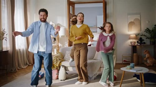 Family Fun: Parents and Children Dancing Indoors