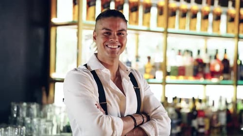 Confident Smiling Barman Posing at a Modern Bar