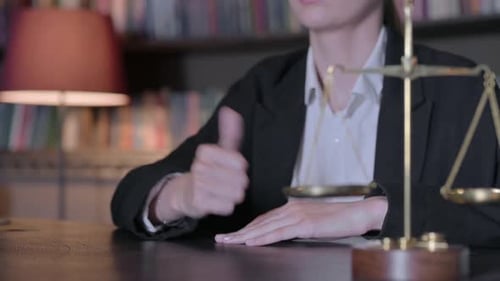 Close Up of Thumbs Up by Female Judge in Court, Scale of Justice