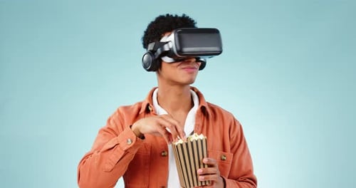 Man wearing VR Goggles Eating Popcorn