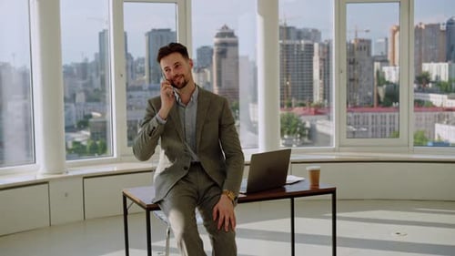 Young Man Manager Worker Boss Specialist Professional Businessman Sitting on Table in Office Looking