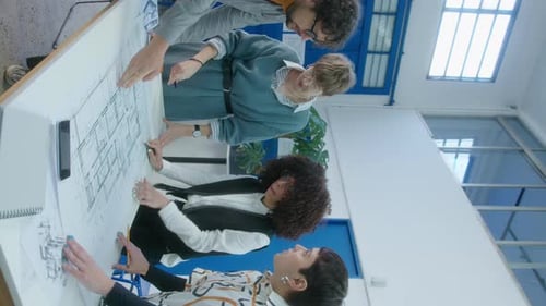 Company of Architects Discussing Floor Plan on Office Meeting