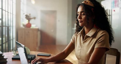 Smiling Woman Using Laptop Computer at Home