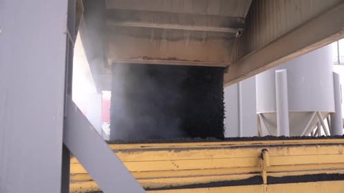 Asphalt prepared to be laid on the roads is loaded on trucks