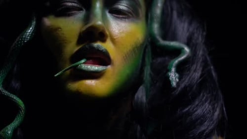 Woman in Medusa Makeup with Snakes in Hair