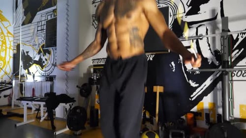 Muscular Afro American Sportsman Skipping with a Jump Rope at Sport Club Strong African Athlete with