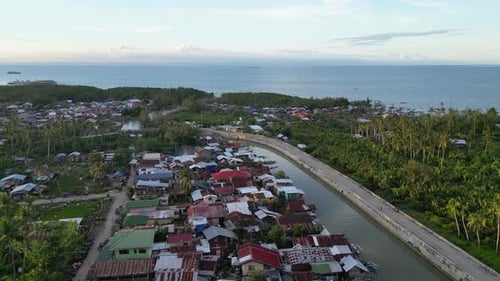 Village with Houses and Highway Stretching to Ocean