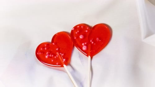 Two Heart Lollipops on a White Cloth