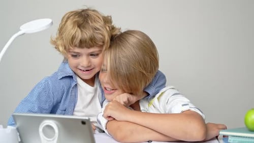 Middle Primary School Students Boy Girl Remotely Studying Writing Book Homework and Tablet at Class