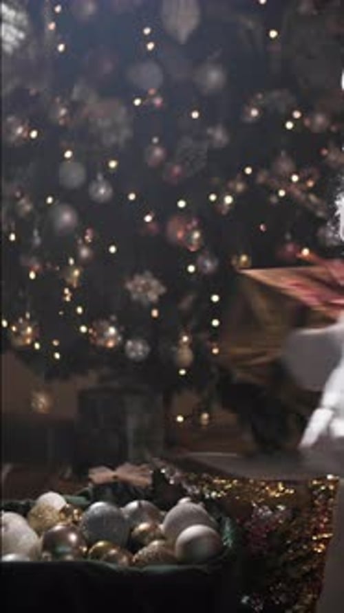 Christmas Holidays Hands in Santa's Gloves Take a Gift in a Beautiful Package Against the Background