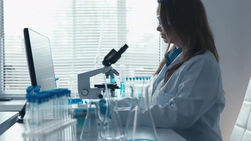 A Dedicated Scientist is Carefully Analyzing Various Samples in a Modern Stateoftheart Laboratory