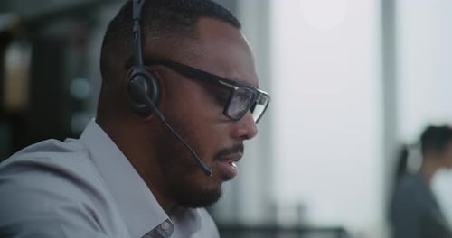Close Up of African American Hotline Operator in Headset Having Conversation on Call