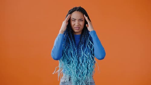 Woman Massaging Temples Due to Headache Discomfort