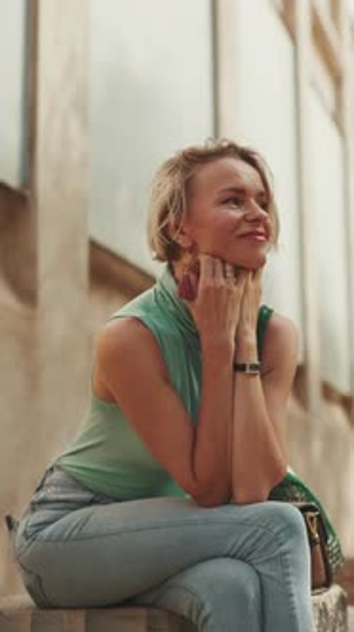 Woman Smiling and Relaxing Outdoors in City
