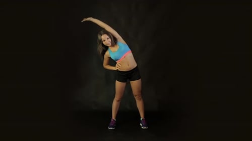 Active Woman Exercising and Stretching on Black Background