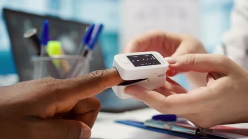 Doctor Measures Patient Vitals with Pulse Oximeter