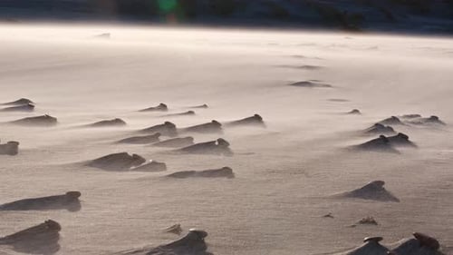 Sand floating in the strong wind on the beach