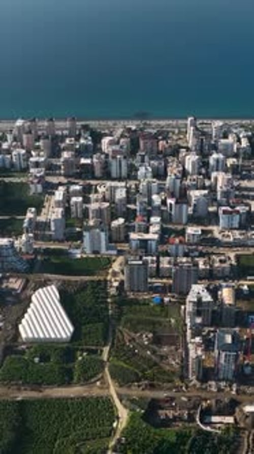 Vídeo vertical: un edificio sueña con una perspectiva aérea sobre la construcción de viviendas en medio de la belleza mediterránea