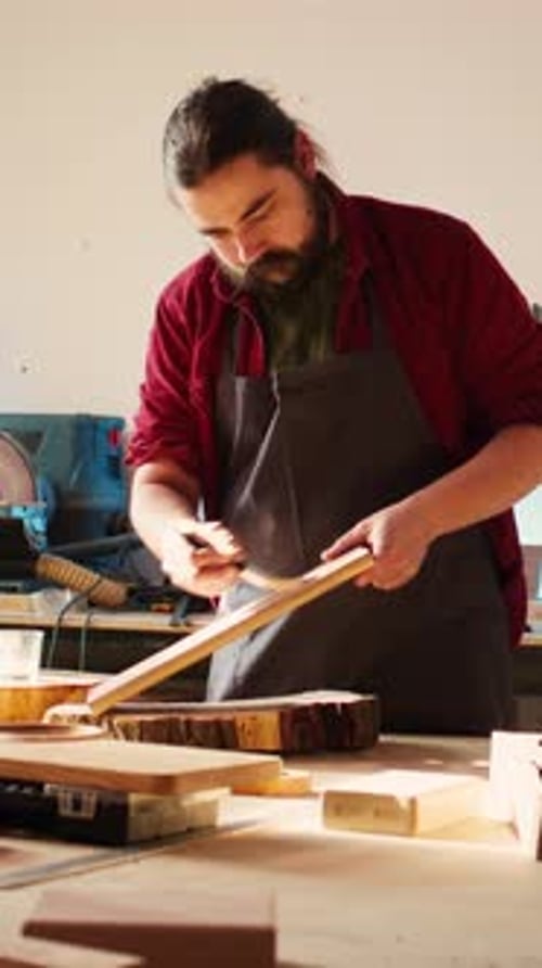 Vertical Video Woodworking Expert in Studio Doing Putting Coats of Oil on Wood Plank