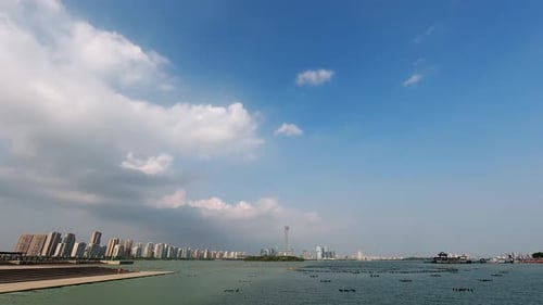 Time Lapse Cityscape at Daytime Blue Sky White Clouds Pass Over the IFS Building and Jingji Lake