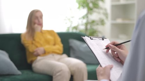 Woman Discussing Concerns with Doctor During Therapy Session