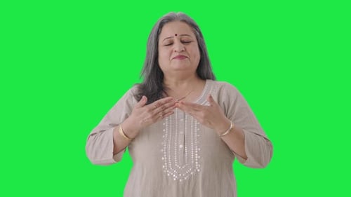 Indian old woman doing breathe in breathe out exercise Green screen