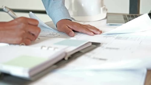 architect engineer working on house blueprint of real estate project at workplace.