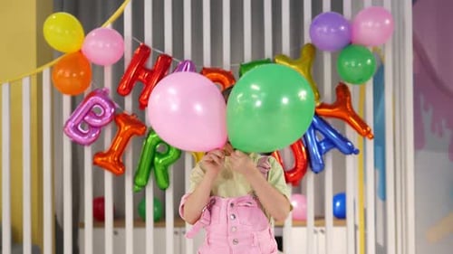 Girl Celebrates Birthday with Balloons and Smiling