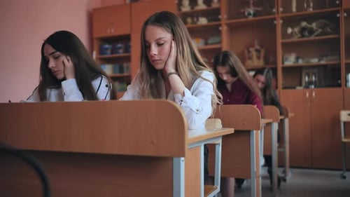 Attentive Teen Students Listening in Classroom Setting