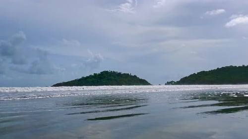 Sea waves splashing on sandy shore of Palolem Beach Goa India 4K