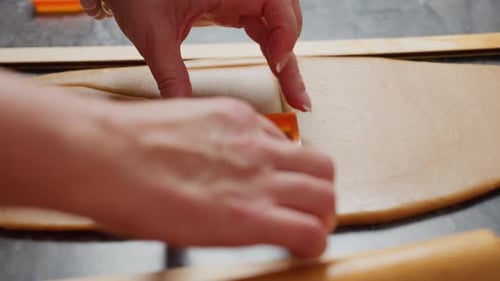 Woman's Hands Use Cookie Cutter on Dough