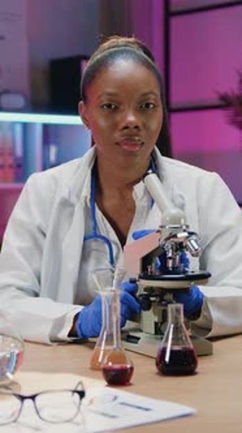 Female Scientist Working with Microscope in Lab