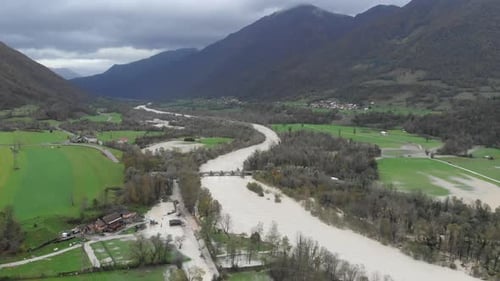 soca river flooding near tolmin slovenia in autumn, high water aerial shot