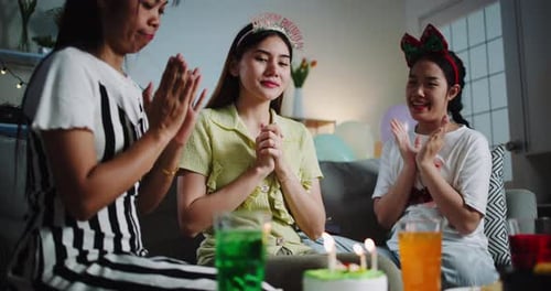 Young Women Celebrate Birthday with Cake and Friends