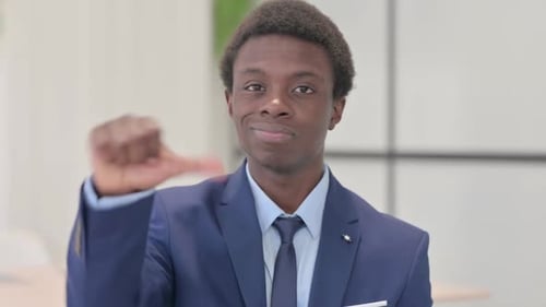 Portrait of Young African Businessman showing Thumbs Down