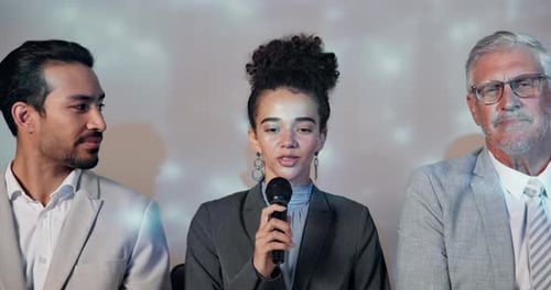 Woman Speaks into Microphone During Corporate Meeting