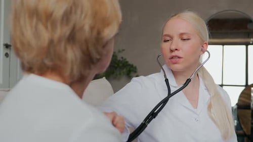 The Doctor Uses a Stethoscope at the Patient's Home Visit