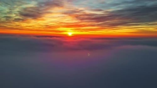 Orange sunset above the clouds.