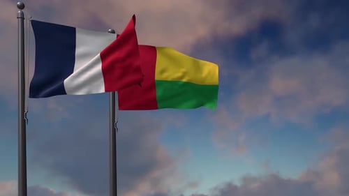 Flags of France and Guinea-Bissau Waving in Blue Sky