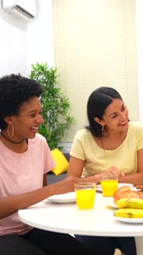 Young Adults Eating Breakfast at Table Indoors