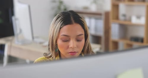 Business woman, computer and face while working in an office while serious and focus on project