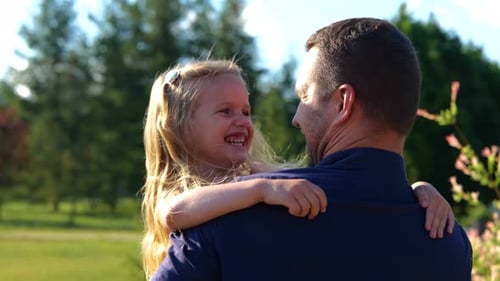 Rear of Young Happy Father Holding His Little Daughter and Smiling Close Up of Pretty Cute Child