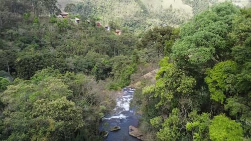 Peaceful Waterfall Flowing Through Green Forest Landscape